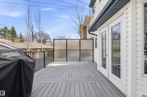Spacious outdoor deck featuring composite decking and black metal railings - 8730 92A Avenue, Edmonton, AB - Outdoor With Deck Patio Veranda With Exterior