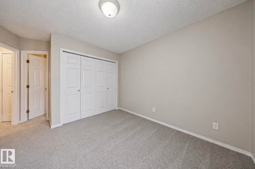 Interior room featuring light gray wall paint, gray carpet, and white trim - 103 12110 119 Ave, Edmonton, AB - Indoor Photo Showing Other Room