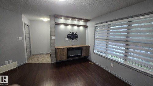 3617 Weidle Bend Bend, Edmonton, AB - Indoor Photo Showing Other Room With Fireplace