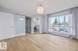 Light wood-finish flooring complements the wide picture window - 