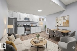 Open-concept living space featuring wood-finish flooring throughout - 