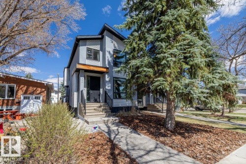 Contemporary two-story exterior featuring light gray siding and black trim accents - 8706 88 Avenue, Edmonton, AB - Outdoor