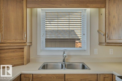 Double basin stainless steel sink with a chrome faucet - 18227 76 Avenue, Edmonton, AB - Indoor Photo Showing Kitchen With Double Sink