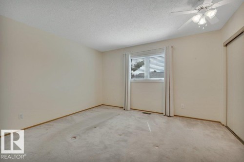 Neutral-toned walls and carpeted flooring define this room - 18227 76 Avenue, Edmonton, AB - Indoor Photo Showing Other Room