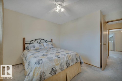 Carpeted room featuring a ceiling fan with integrated lighting - 18227 76 Avenue, Edmonton, AB - Indoor Photo Showing Bedroom