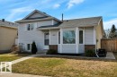 Split-level residence featuring light gray siding with brick accents and a bay window - 18227 76 Avenue, Edmonton, AB  - Outdoor 