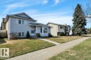 Split-level residence featuring light-colored siding and a dark shingle roof - 18227 76 Avenue, Edmonton, AB  - Outdoor With Facade 