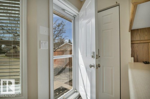 Entryway featuring a white paneled door, sidelite window, and an additional interior door - to the backyard and garage - 18227 76 Avenue, Edmonton, AB - Indoor Photo Showing Other Room