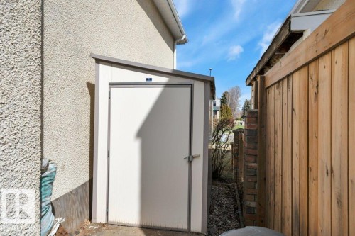 Compact exterior storage shed featuring a sloped roof and a single panel door with a latch - 18227 76 Avenue, Edmonton, AB -  With Exterior