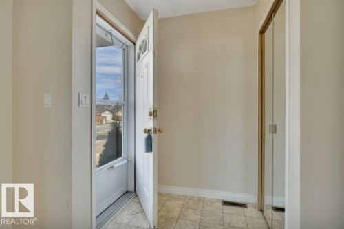 Entryway featuring a white paneled door with a glass insert, a storm door, and neutral wall paint - 18227 76 Avenue, Edmonton, AB - Indoor Photo Showing Other Room