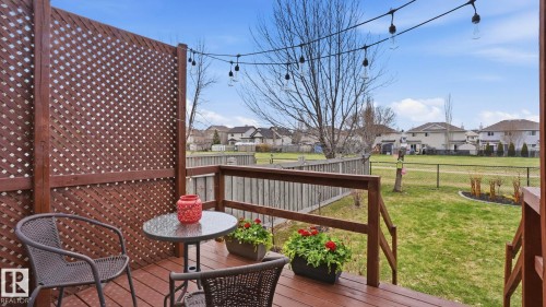 Spacious outdoor deck with dark wood-finish flooring and railing - 80 287 Macewan Road, Edmonton, AB - Outdoor With Deck Patio Veranda With Exterior