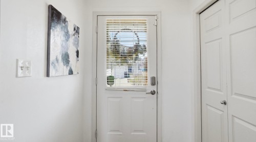 Entry door with integrated blinds and a smart lock system - 80 287 Macewan Road, Edmonton, AB - Indoor Photo Showing Other Room