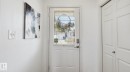 Entry door with integrated blinds and a smart lock system - 80 287 Macewan Road, Edmonton, AB  - Indoor Photo Showing Other Room 