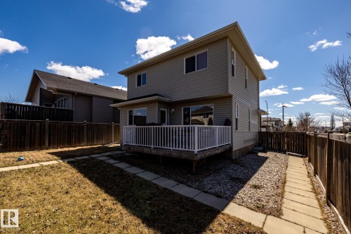 Two-story residence featuring light-colored siding and a rear deck with white railings - 55 Lamplight Cove, Spruce Grove, AB - Outdoor With Exterior