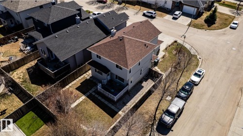 Two-story residence with light gray siding and a brown shingle roof - 55 Lamplight Cove, Spruce Grove, AB - 
