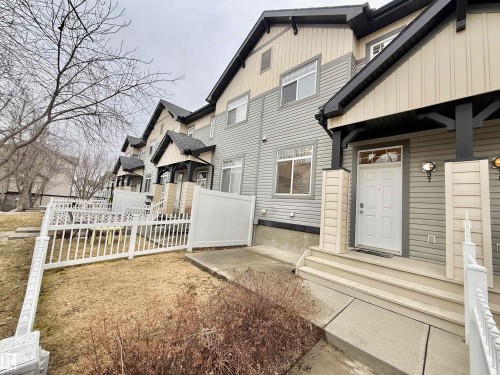 Gray horizontal siding exterior with contrasting cream vertical siding accents and dark trim details - 97 465 Hemingway Road, Edmonton, AB - Outdoor