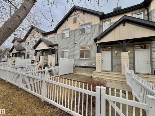 Townhome exterior featuring multi-toned siding, white trim, and black gables - 97 465 Hemingway Road, Edmonton, AB - Outdoor