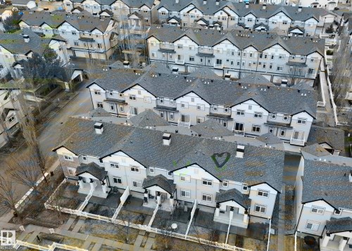 Townhome community featuring multi-story residences with gabled roofs and individual front patios - 97 465 Hemingway Road, Edmonton, AB - Other