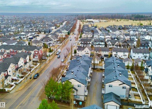 Aerial perspective showcasing a residential community with varied architectural styles - 97 465 Hemingway Road, Edmonton, AB - Outdoor With View