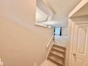 Carpeted staircase with white handrail leading to an upper level with light-colored carpeting - 97 465 Hemingway Road, Edmonton, AB  - Indoor Photo Showing Other Room 