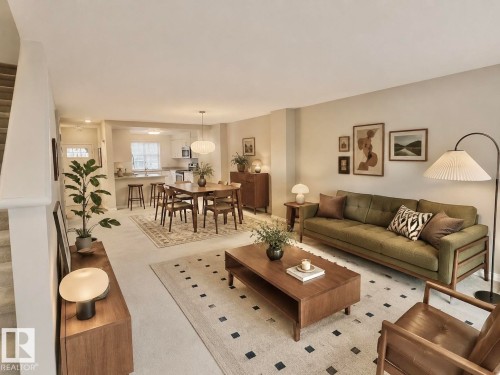 Open-concept living area featuring light-toned walls and carpeted flooring - 97 465 Hemingway Road, Edmonton, AB - Indoor Photo Showing Living Room