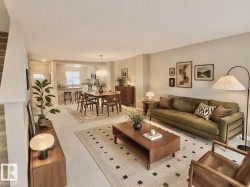 Open-concept living area featuring light-toned walls and carpeted flooring - 