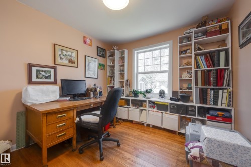 Room featuring wood-finish flooring, a double-hung window, and a ceiling-mounted light fixture - 11516 72 Avenue, Edmonton, AB - Indoor Photo Showing Office