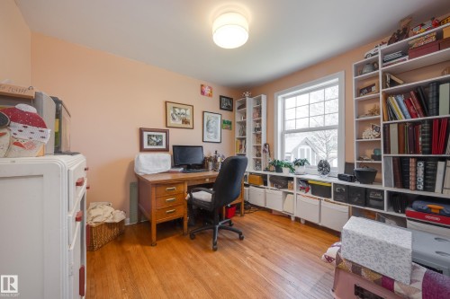 Room featuring wood-finish flooring and a central ceiling light fixture - 11516 72 Avenue, Edmonton, AB - Indoor Photo Showing Office