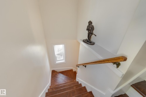 Hardwood treads and risers with a natural wood handrail - 11516 72 Avenue, Edmonton, AB - Indoor Photo Showing Other Room
