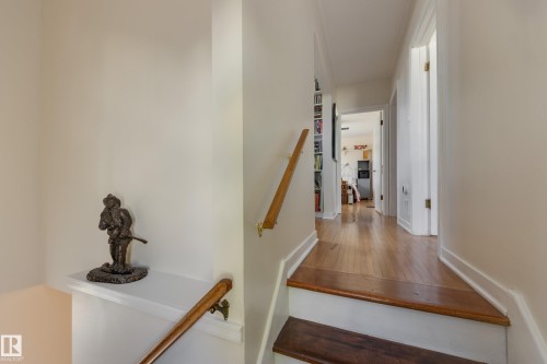 Wood-finish flooring throughout the hallway and staircase - 11516 72 Avenue, Edmonton, AB - Indoor Photo Showing Other Room