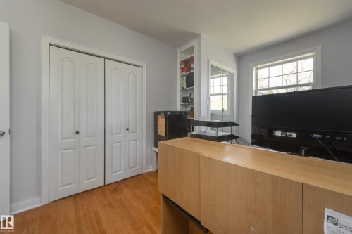 Room featuring wood-finish flooring, light grey wall paint, and white trim - 11516 72 Avenue, Edmonton, AB - Indoor