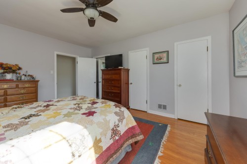Interior room featuring light gray walls and wood-finish flooring - 11516 72 Avenue, Edmonton, AB - Indoor Photo Showing Bedroom