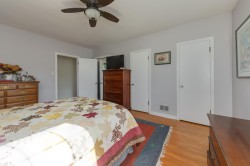 Interior room featuring light gray walls and wood-finish flooring - 