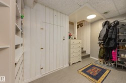 Built-in shelving and cabinetry against vertical plank wall paneling - 