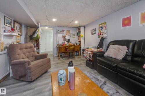 Recessed lighting illuminates this versatile room with light grey walls and wood-finish flooring - 11516 72 Avenue, Edmonton, AB - Indoor Photo Showing Living Room
