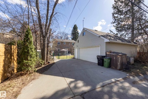 Detached two-car garage with light-colored siding and a white garage door - 11516 72 Avenue, Edmonton, AB - Outdoor