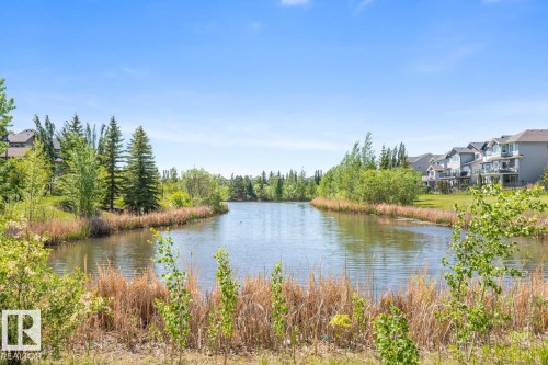 Water feature surrounded by natural foliage and mature trees - 7641 Schmid Crescent, Edmonton, AB - Outdoor With Body Of Water With View