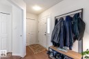 Entryway featuring wood-finish flooring, a white paneled door with a frosted glass insert, and a flush-mount ceiling light - 7641 Schmid Crescent, Edmonton, AB  - Indoor 