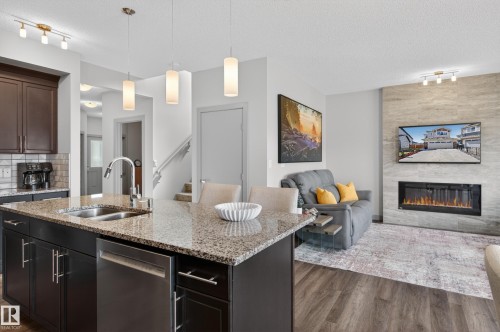 934 Berg Place, Leduc, AB - Indoor Photo Showing Kitchen With Fireplace With Double Sink With Upgraded Kitchen