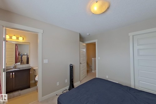 Bedroom featuring light neutral wall paint, carpet flooring, and a white paneled closet door - 295 401 Southfork, Leduc, AB - Indoor