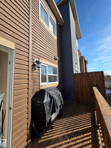 Exterior deck featuring wood flooring and a perimeter privacy fence - 295 401 Southfork, Leduc, AB - Outdoor With Exterior