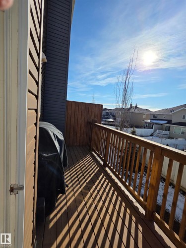 Expansive wood deck with a full-height privacy wall and wood balusters - 295 401 Southfork, Leduc, AB - Outdoor With Exterior