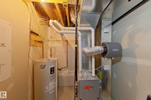 Mechanical room featuring a water heater, furnace, humidifier, and visible ductwork - 295 401 Southfork, Leduc, AB - Indoor Photo Showing Basement