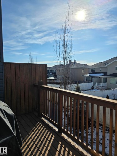 Wood-decked balcony featuring a privacy wall, wood baluster railing, and a partial outdoor cover - 295 401 Southfork, Leduc, AB - Outdoor With Balcony