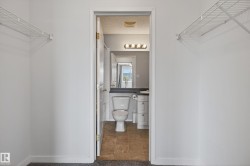 Walk-through closet featuring wire shelving on opposing walls - 