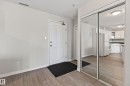 Entryway featuring wood-finish flooring, a paneled door, and mirrored closet doors - 319 16303 95 Street, Edmonton, AB  - Indoor Photo Showing Other Room 
