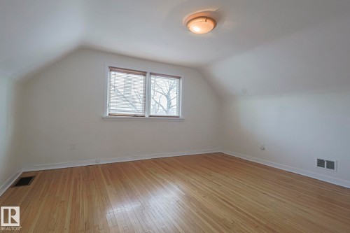 Room featuring wood flooring, white walls, and a sloped ceiling - 11507 72 Avenue, Edmonton, AB - Indoor Photo Showing Other Room