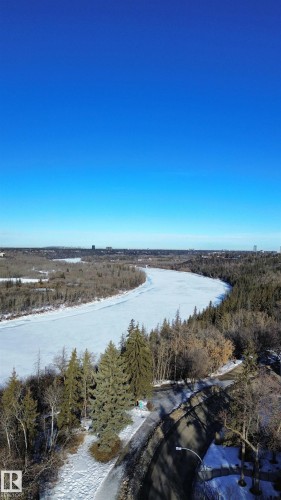 Winding river with frozen surface, surrounded by mature evergreen and deciduous trees - 11507 72 Avenue, Edmonton, AB - Outdoor With Body Of Water With View