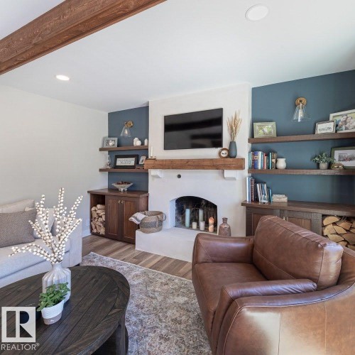 Living area featuring a white plastered fireplace with a substantial wood mantel - 12423 28A Avenue, Edmonton, AB - Indoor Photo Showing Living Room With Fireplace