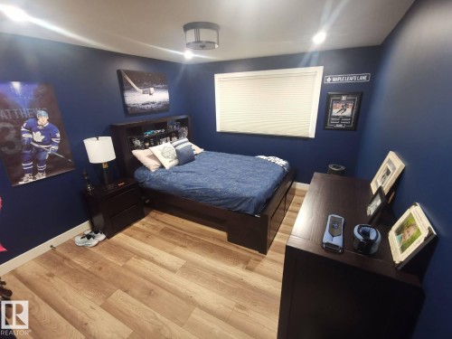Bedroom featuring wood-finish flooring, recessed lighting, and a window with blinds - 12423 28A Avenue, Edmonton, AB - Indoor Photo Showing Bedroom